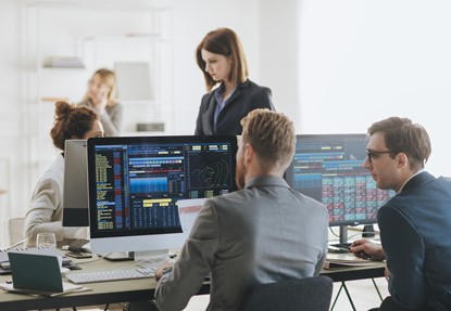 Group of businessmen and businesswomen stock brokers working at office